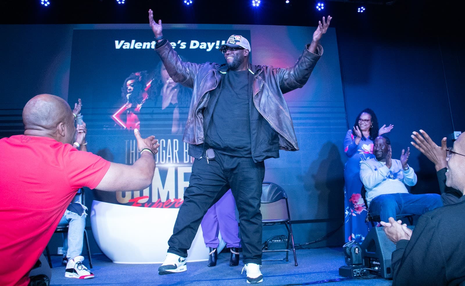 A comedian working the crowd from the stage