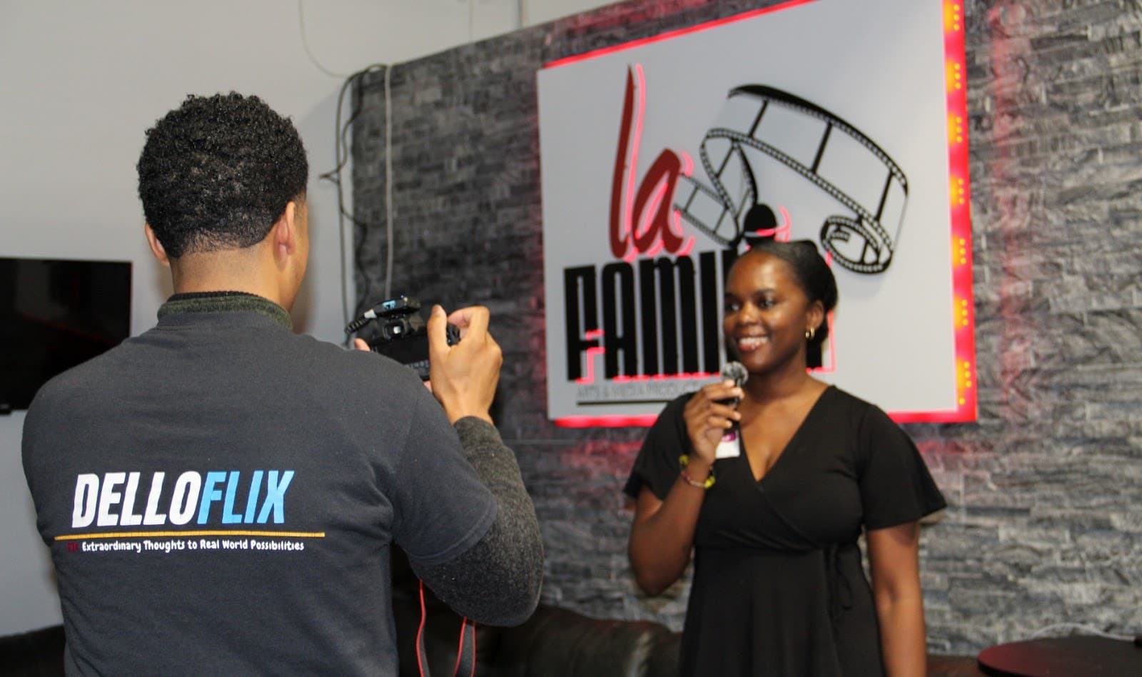A DelloFlix camera operator filming an on-site interview