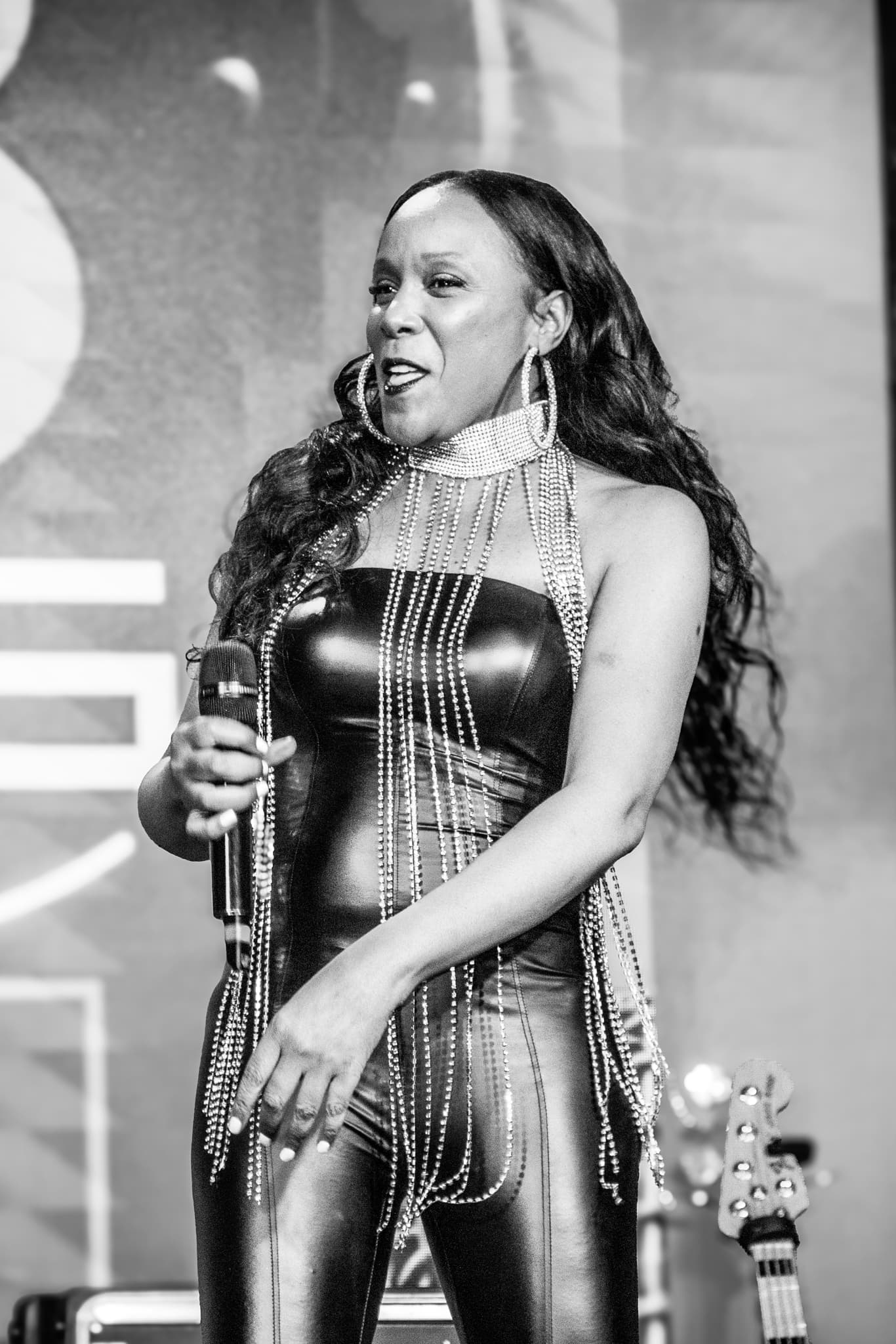 Black and white portrait of an R&B vocalist singing on stage