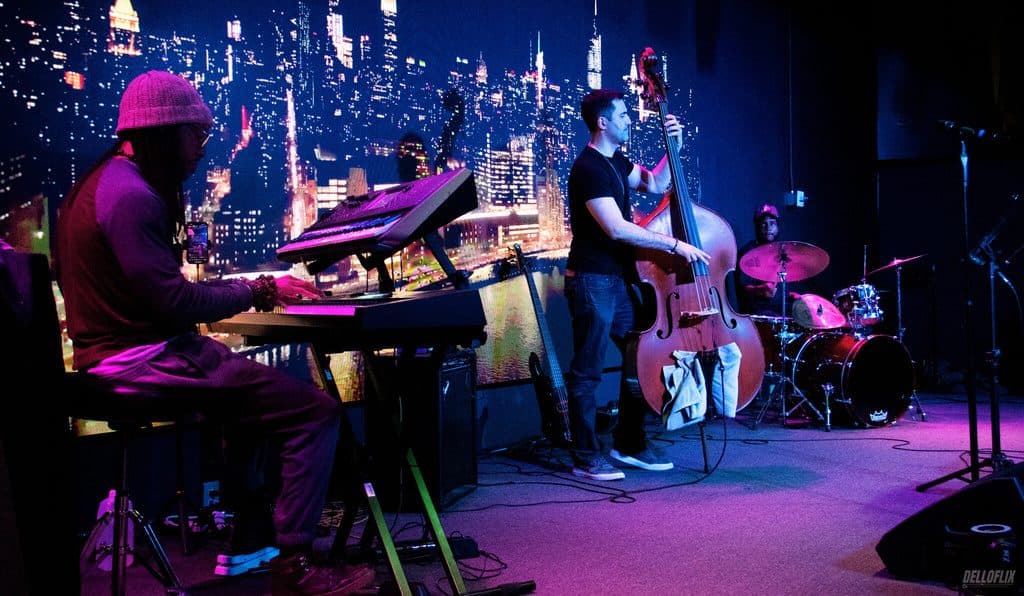 Jazz band performing on stage in front of a city skyline backdrop